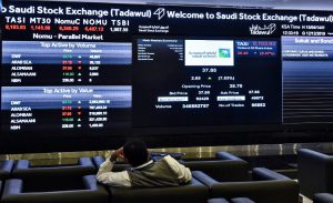 Asian markets defensive as oil tumbles
