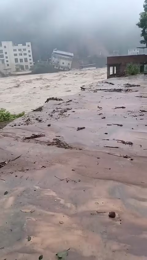 A building collapses due to landslides and floods in Meizhou City, Guangdong, China in this screen grab obtained from a social media video