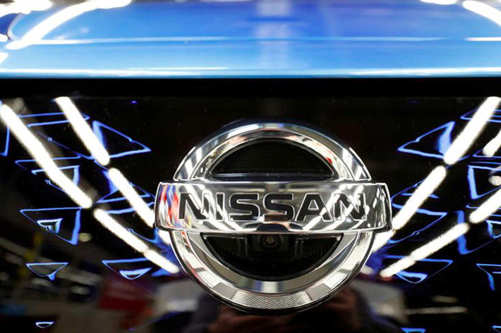 The logo of Nissan is seen on a car ahead of a news conference at Nissan's Sunderland plant.