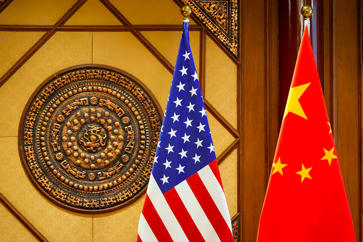 Flags of the U.S. and China sit in a room where U.S. Secretary of State Antony Blinken meets with China's Minister of Public Security Wang Xiaohong at the Diaoyutai