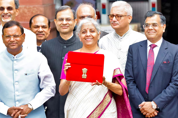 India's Finance Minister Nirmala Sitharaman holds up a folder with the Government of India's logo as she leaves her office to present the union budget in the parliament in New Delhi, India