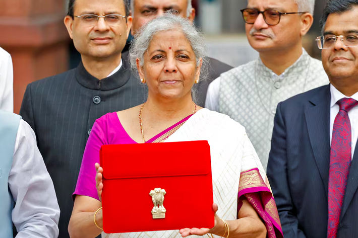 India's Finance Minister Nirmala Sitharaman holds up a folder with the Government of India's logo as she leaves her office to present the union budget in the parliament in New Delhi.