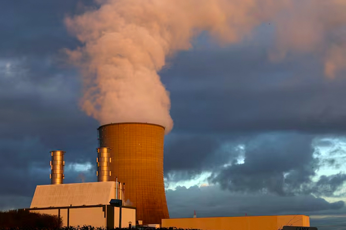 Smoke billows from a chimney at a combined-cycle gas turbine power plant while coinciding the COP28 is being held in Dubai, in Drogenbos,