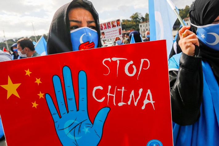 Ethnic Uighur demonstrators take part in a protest against China