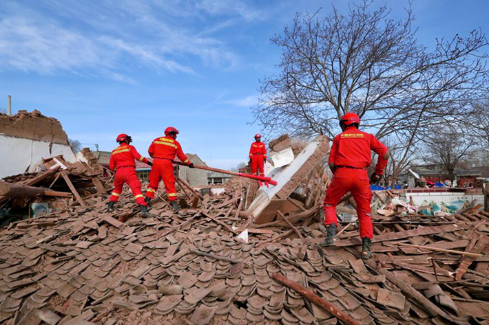 Rescuers work amid the rubble at Shiyuan village following the earthquake in Jishishan county