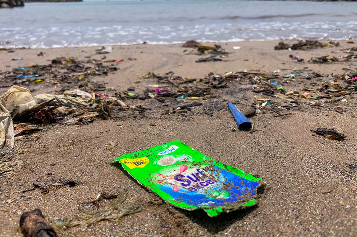 A view of an empty plastic sachet of Unilever's Surf Excel laundry detergent on a beach on Crow Island, Colombo.