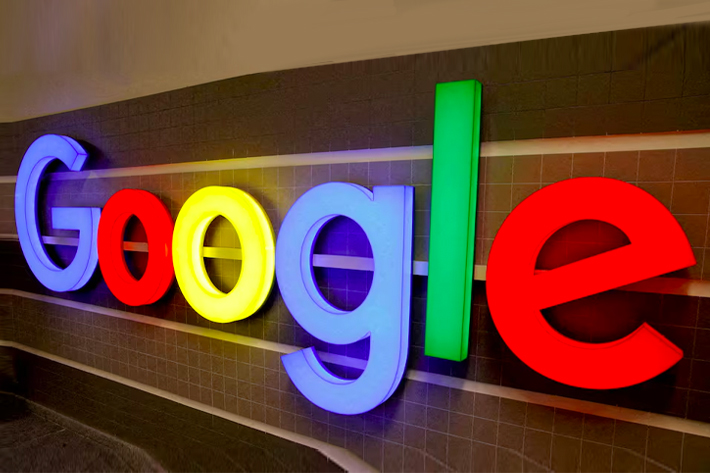 An illuminated Google logo is seen inside an office building in Zurich, Switzerland.