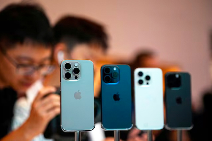 People look at the new iPhone 15 Pro as Apple's new iPhone 15 officially goes on sale across China at an Apple store in Shanghai, China.