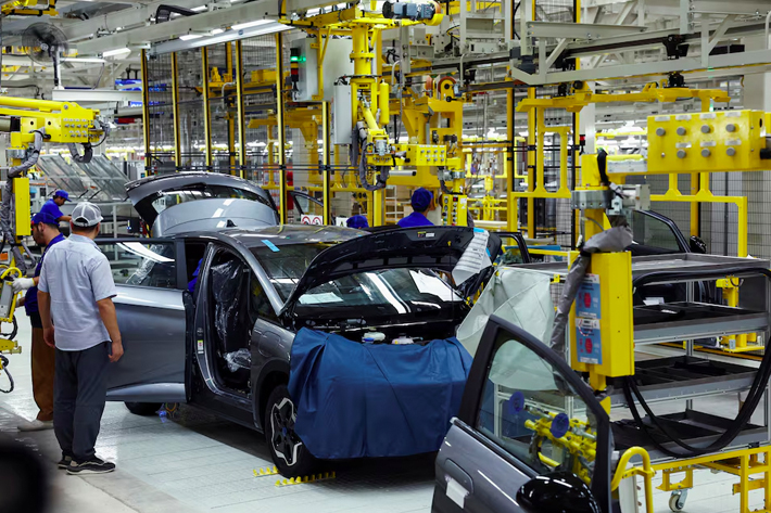 Workers assemble an EV car inside BYD's first electric vehicle (EV) factory in Southeast Asia