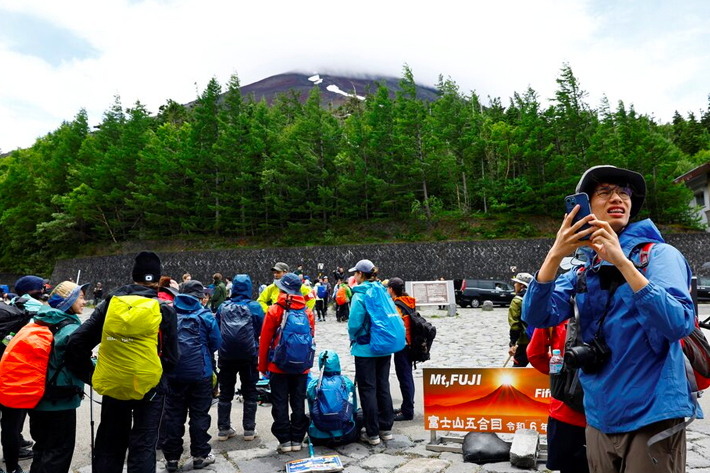 Climbers gather on the first day of the climbing season at Fuji Yoshidaguchi Trail (Yoshida Route) at the fifth station on the slopes of Mount Fuji, Japan