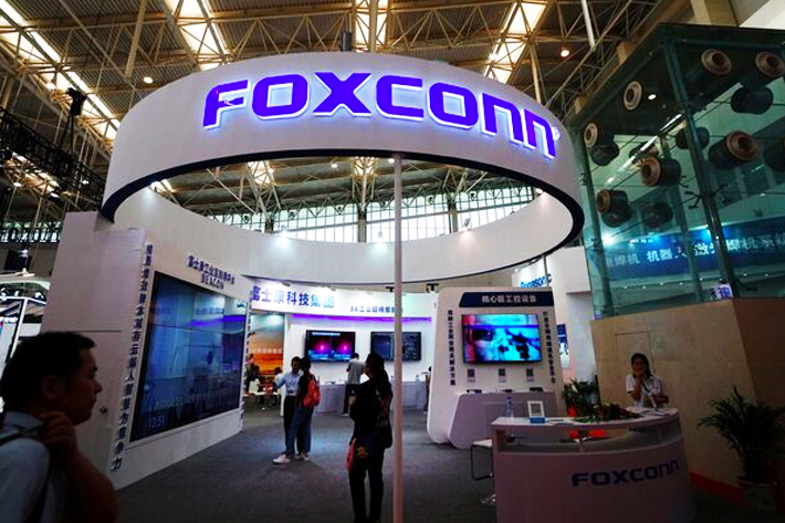 Visitors are seen at a Foxconn booth at the World Intelligence Congress in Tianjin, China.