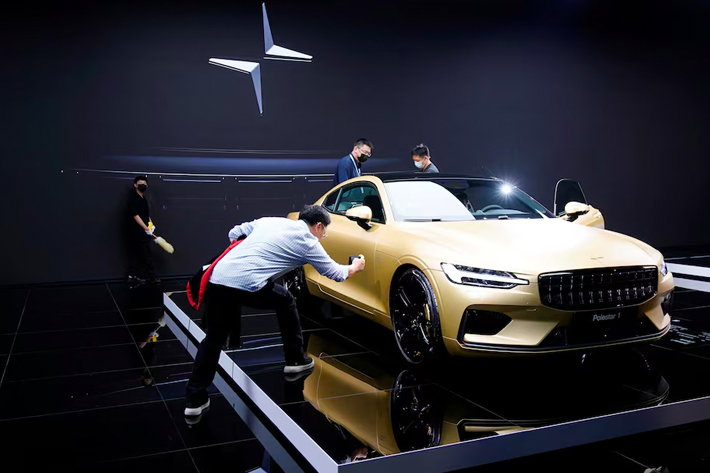 Visitors check a Polestar 1 hybrid vehicle displayed during a media day for the Auto Shanghai show in Shanghai, China.