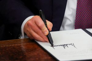 Trump signs executive orders and pardons for January 6 defendants in the Oval Office at the White House